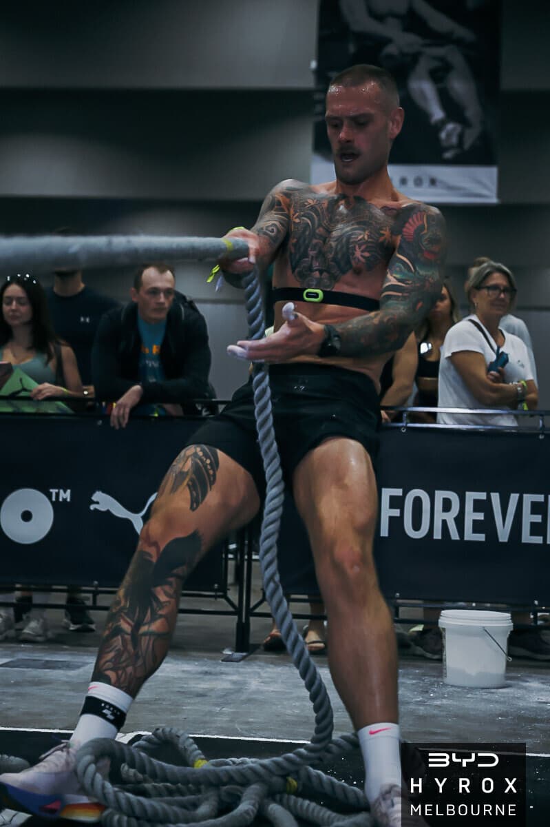 Jordon Mudge hauling the sled pull rope at HYROX Melbourne